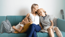 Mom with two children sitting on couch