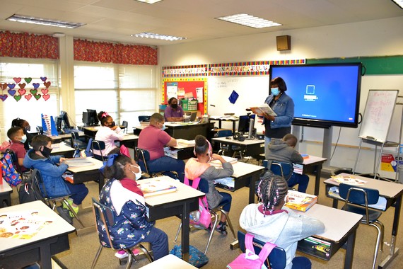 white hills lady reading in front of class