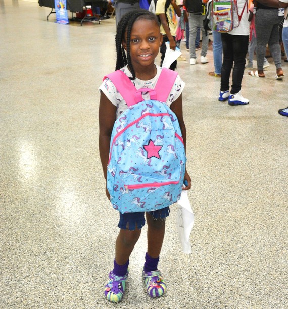 girl with pink and blue backpack