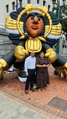 Image of Cultural Economy team in front of Spy Boy installation by artist Compton III