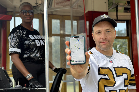 Rider in Saints jersey taking streetcar