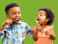 Two children brushing their teeth 