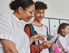 Students Pointing at Smartphone