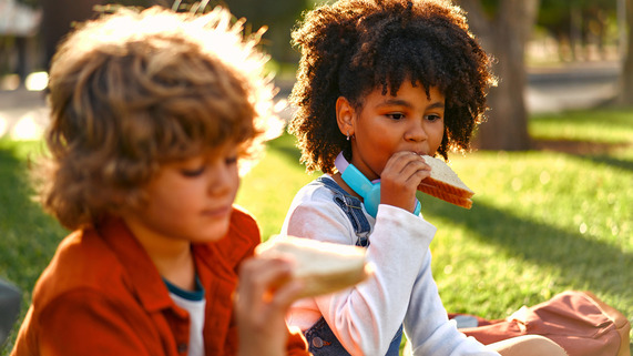 Kids eating lunch at the park