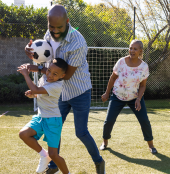 Family playing soccer together