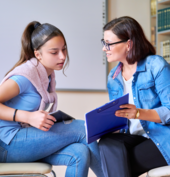 Teenage girl meeting with a teacher