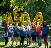 NEDA Team holding balloons