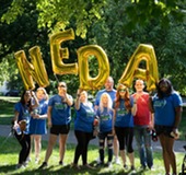 NEDA Team holding balloons