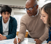 Professor working with two students
