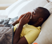Man lying in bed with a cold