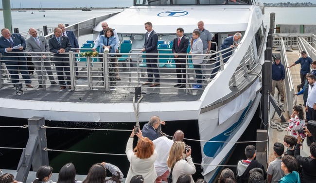 Lieutenant Governor Driscoll braking champagne bottle on new Lynn ferry