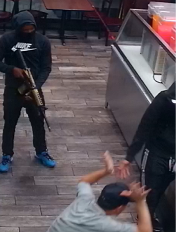 man with gun in a store