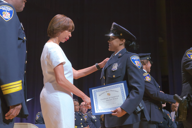 mayor and officer on stage