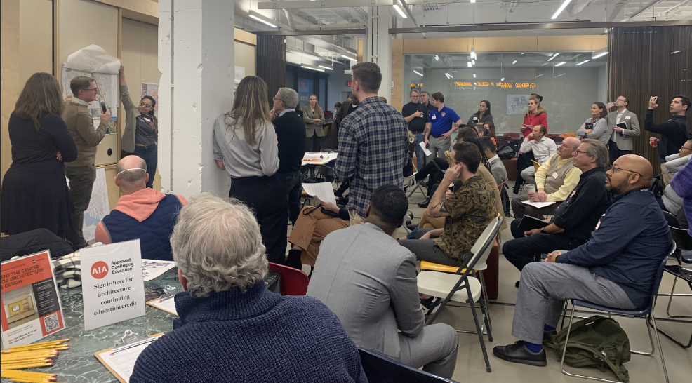 Group of people standing at a meeting
