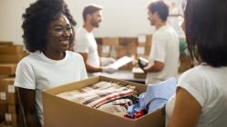 Volunteers carrying boxes of various donations