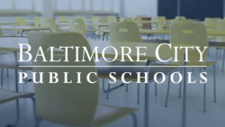 "Baltimore City Public Schools" with classroom chairs and desks in the background