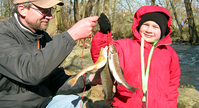 Photo of man and boy with caught fish