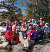 Photo of hikers sitting on a rock