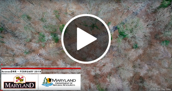 Still shot of video intro showing aerial footage of hikers