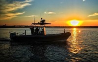 Photo of patrol boat at sunrise
