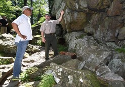 Photo of Lt. Governor Boyd Rutherford observing a rock wall at Patapsco Valley State Park