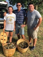 Photo of people with bushels of crabs