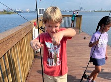 Photo of child with fishing pole and fish