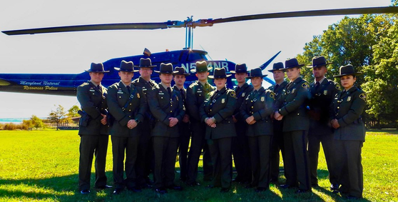 Photo of NRP officers in front of helicopter