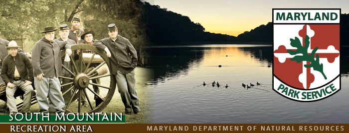 Header image featuring military reenactors with a cannon and sunset over the park lake