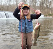 Young angler with a trout, photo by Christopher Wike.