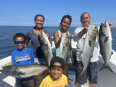 Photo of people on a boat holding fish