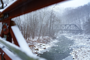 A Bridge crossing a river in a snowy scene