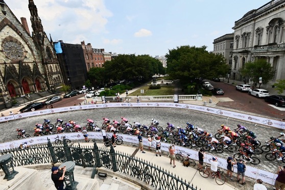The peloton of the Maryland Cycling Classic Men's Race passes historic Mount Vernon Place, the Washington Monument and the Peabody Institute. 