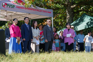 Korean Community members standing with Friends of Patapsco Valley State Park tent