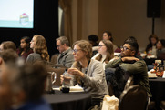 People sitting at tables during a seminar