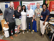 People at a conference display booth for the Maryland Department of Natural Resources