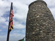 Stone tower with American and Maryland flags