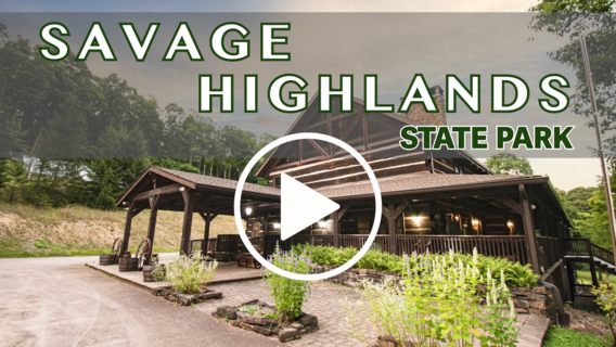 Rustic lodge building exterior with video play button