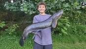 Young man holding a large fish