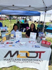 Two MDOT employees tabling at an outreach event