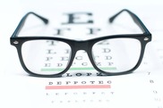 A photo of a pair of glasses on top of an eye chart
