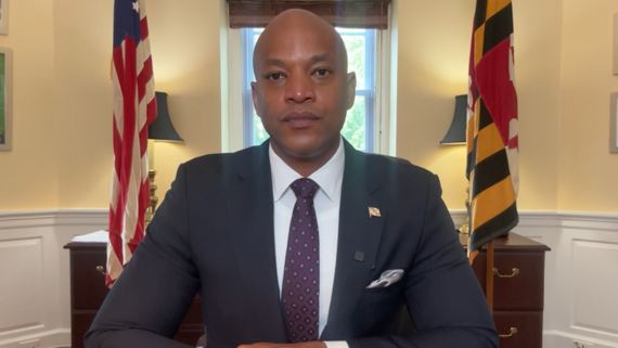 Governor Moore seated at office desk