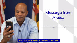 Governor Moore looking at phone while seated