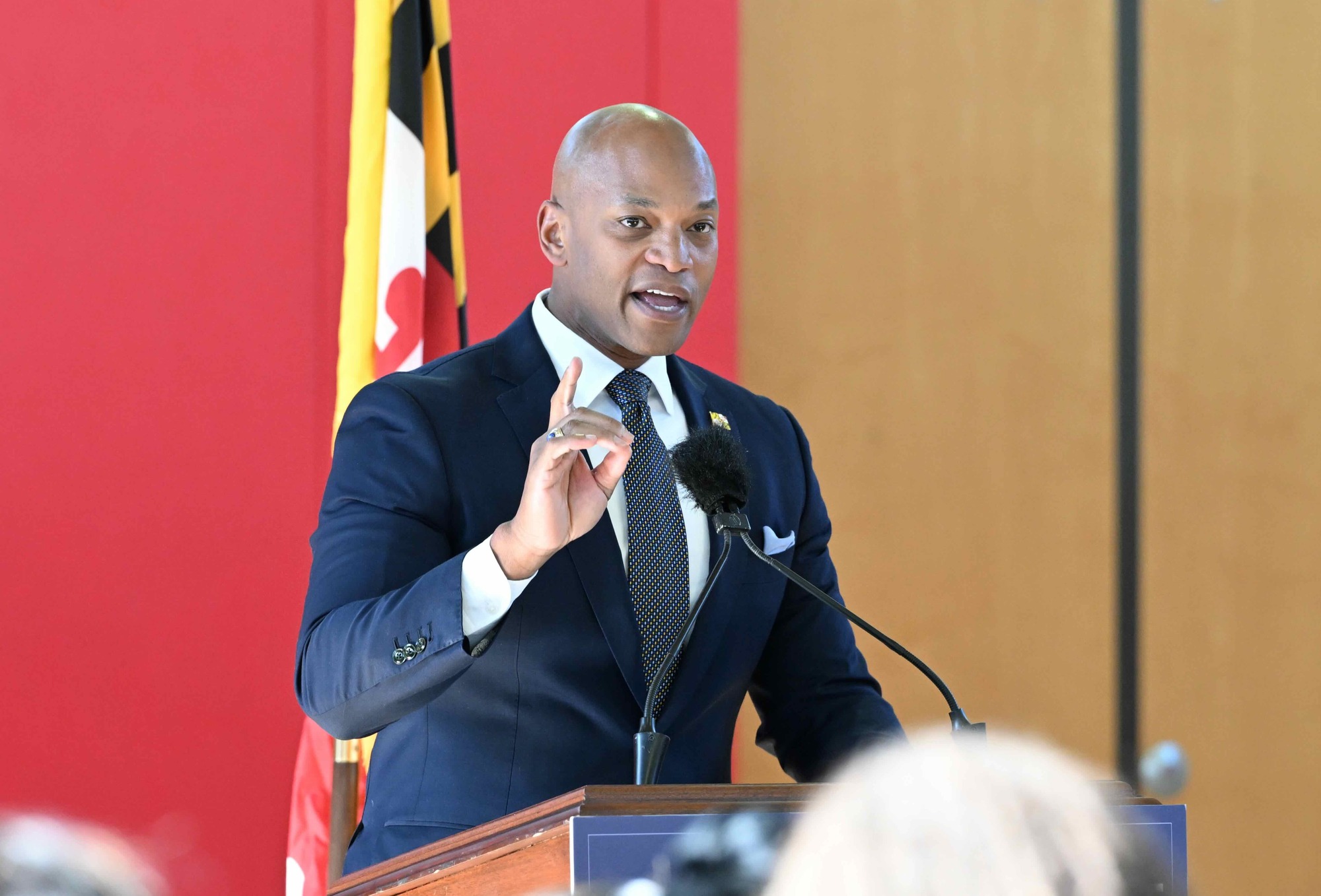 Governor Moore gesturing while standing at lecturn