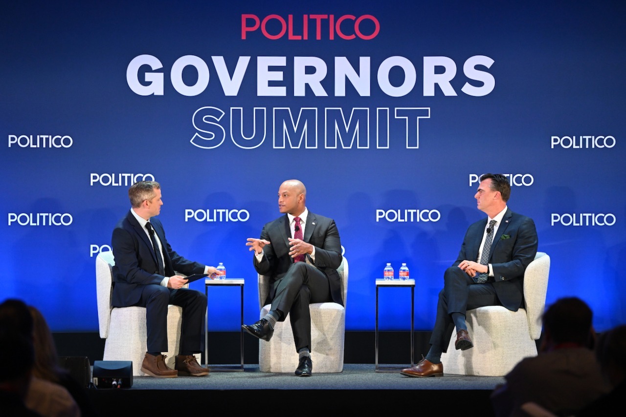 Governor Moore seated on stage