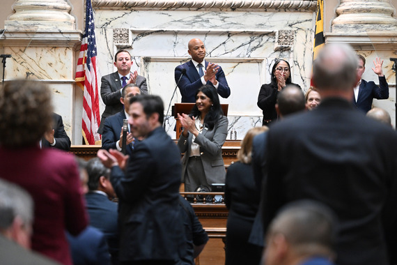 Lt. Governor Aruna Miller stands below Gov. Wes Moore as he delivers his State of the State address in the House chambers.