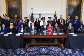 Governor Wes Moore, Lt. Governor Aruna Miller, General Assembly leadership, and advocates gather to celebrate the signing of SB245/HB444.