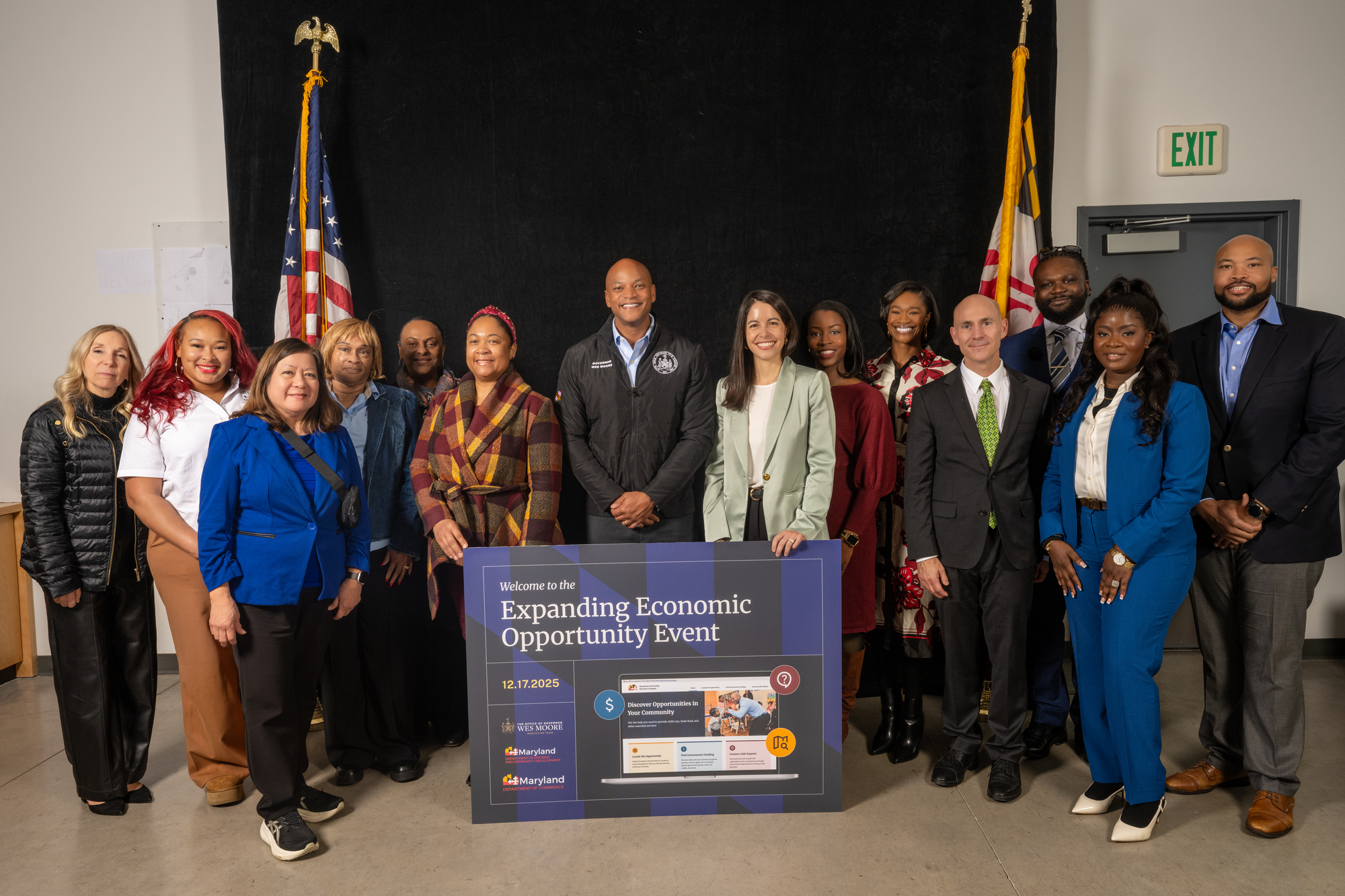 A group photo at the Expanding Economic Opportunity Event held on December 17, 2025. Maryland Governor Wes Moore stands in the center alongside Chief Innovation Officer Francesca Ioffreda and a diverse group of child care center owners and association representatives, in front of a large sign showcasing the Maryland Community Business Compass.