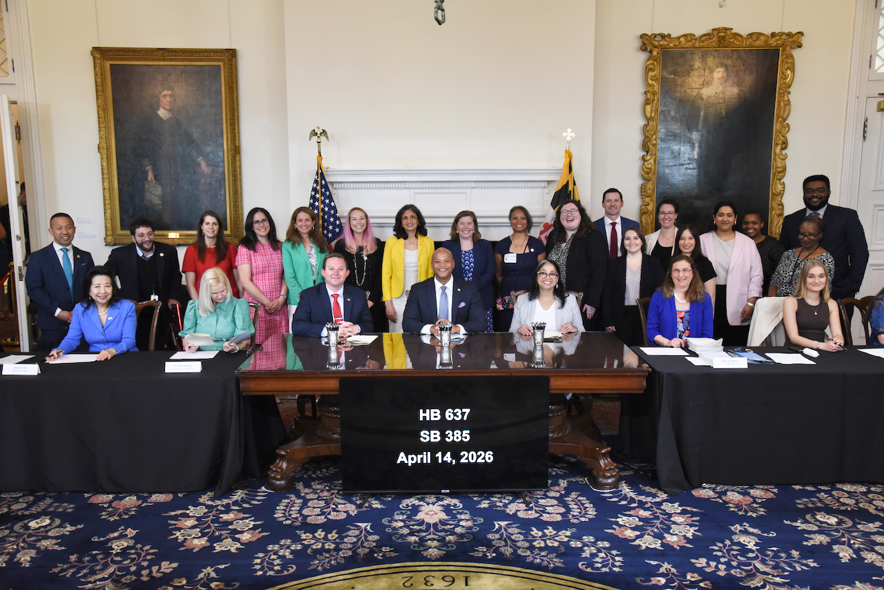 Governor Moore with group at table of bill signing