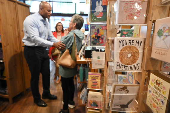 Greeting card in foreground as Governor Moore talks with Marylander